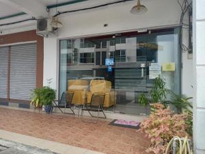 a store front window with chairs in it at M Three Hotel by SECOMS in Kampong Batu Tiga