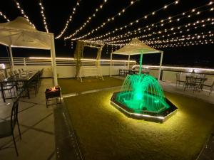 a deck with a table and chairs and lights at Royal GM Plaza in Jaipur