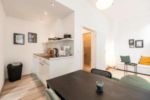 eine Küche, ein Esszimmer mit einem Tisch, eine Küche und ein Wohnzimmer in der Unterkunft Exklusive Wohnung am Weserdeich in Bremen