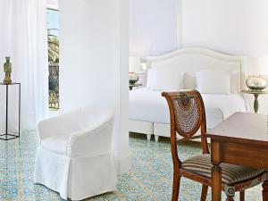 A bed or beds in a room at Caramel, A Grecotel Resort to Live