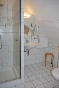 a bathroom with a sink and a shower and a toilet at Hôtel sud alsace in Ranspach-le-Bas