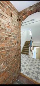 a brick wall with a tile floor and stairs at Stylish 3 bedroom apartment in historic city centre building in Sheffield