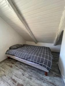uma cama num quarto com tecto em La bergerie em Roubion
