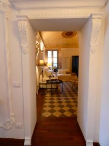 a hallway leading to a living room with a checkered floor at Scappo in Umbria, Residenza Monaldeschi in Orvieto