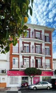 a building with a car parked in front of it at Casa Rosa Nova in Marbella