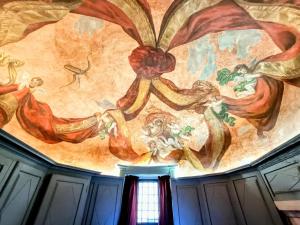 a painting on the ceiling of a building at Les Chambres De La Renaissance in Sainte-Julie