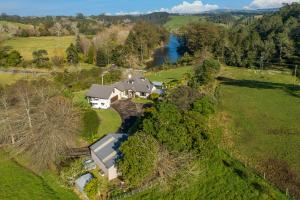 an aerial view of a house with a river at McLaren Lake View in Tauranga