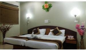 Ein Bett oder Betten in einem Zimmer der Unterkunft FabExpress Vora Corporate Inn