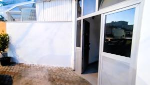 an open door to a white garage with a window at Nuçi's Place, lovely apt with balcony near Blloku in Tirana