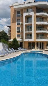 a large apartment building with a large swimming pool at Sunny Residence complex in Sunny Beach