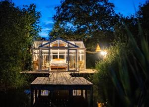 a tiny house in a garden at night at Nids des Marais in Ciney +59 photos