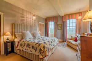 a bedroom with a bed and a couch at Down Farm Manor in Stroud