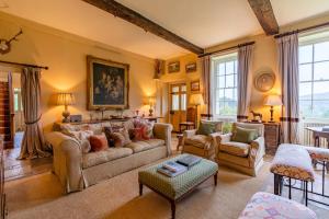 a large living room with a couch and chairs at Down Farm Manor in Stroud