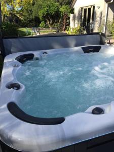 a jacuzzi tub with blue water in it at McLaren Lake View in Tauranga