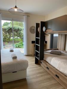 a bedroom with two bunk beds and a window at Hotel Aux Tamaris in Sauzon