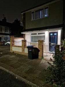 a house with a trash can in front of it at Stylish 2 bed home- short walk to Tottenham Stadium/Stations in London