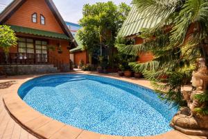 a large blue swimming pool in front of a house at Bungalow Phuket in Kamala Beach
