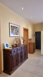 a large room with a wooden cabinet and a wall at Holidays Home Comporta in Comporta