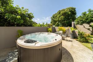 a hot tub in the backyard of a house at Villa et grand jacuzzi six personnes visite à la ferme in Saint-Joseph