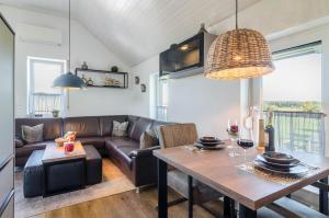 a living room with a couch and a table at Ferienwohnung Romanas in Ostrach