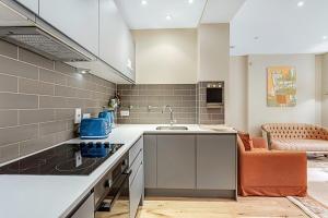 a kitchen with a sink and a counter top at Beautiful Abode in Kensington Olympia in London