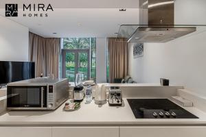a kitchen with a microwave oven and a sink at Mira Holiday Homes - Serviced 1 bedroom in Bluewaters in Dubai