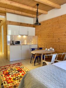 a kitchen and dining room with a table and chairs at Ski in Ski out Slopeside apartments just 50 meters from the Gondola in New Gudauri in Gudauri