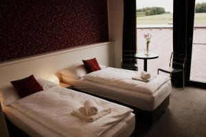 A bed or beds in a room at K-Triumf Resort
