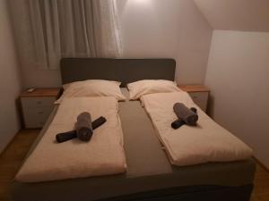 a bed with two pillows on it with at Haus Eichkogel Guntramsdorf in Guntramsdorf