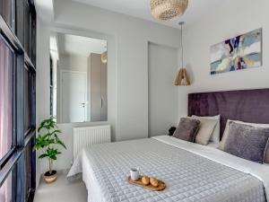 a bedroom with a bed with a tray of bread at Sanders Old Port Thessaloniki in Thessaloniki