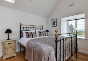 a bedroom with a large bed and a window at Bryn Eithin in Derwen