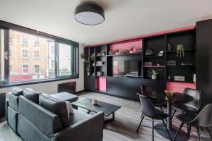 a living room with a couch and a table at The Sassy - Soho - by Frankie Says in London