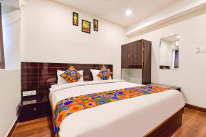 a bedroom with a large bed in a room at FabHotel Shri Krishna in Vadodara