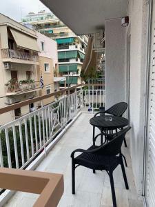 a patio with two chairs and a table on a balcony at Central Piraeus 2 in Piraeus