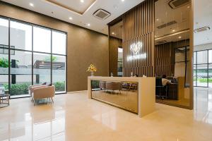 an office lobby with a table and chairs at D'capitale - Feria Homes in Hanoi