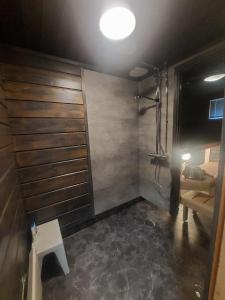 a bathroom with a shower with a bench and a sink at Lomariihi 1 in Muurame