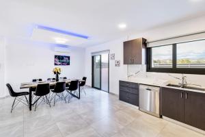 a kitchen and dining room with a table and chairs at Villa Elpida TWO by Ezoria Villas in Timi, Paphos in Ktima