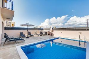 a swimming pool on the roof of a house at Villa Elpida TWO by Ezoria Villas in Timi, Paphos in Ktima