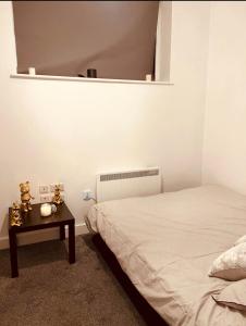 a bedroom with a bed and a table with a mirror at Heart of Sheffield in Sheffield