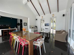 a dining room with a table and chairs at Krabi Beach House, SHA Extra Plus in Ao Nam Mao