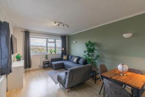 a living room with a couch and a table at Park View - Modern - Parking in Brighton & Hove