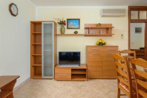 a room with a desk with a computer and a tv at Villa Ana - Peaceful Location in Marčana