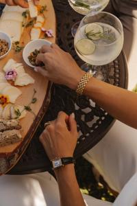 a person eating food on a table with a plate of food at Ribeira Collection Hotel by Piamonte Hotels in Arcos de Valdevez