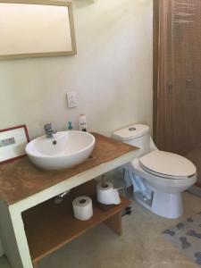 a bathroom with a sink and a toilet at Double Bed, Queen size, small kitchen, terrace, wi-fi- air condition in Cuatunalco
