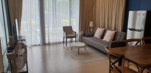 a living room with a couch and a table at Beach Front Condo, Baan Thew Talay, Perfect Choice for Family and Couple in Ban Bo Khaem