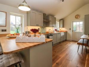 a kitchen with a wooden counter top in a room at Rookery Cottage in Saxmundham