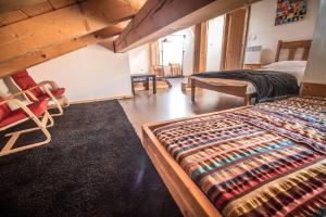 a bedroom with two beds and a rug at Chalet Pomet in Morillon