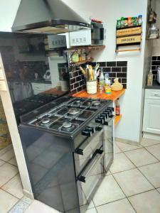 a kitchen with a stove top oven in a kitchen at Villa piscine proche Futuroscope in Buxerolles