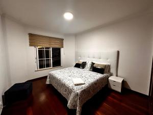 a bedroom with a bed and a window at SÃO GONÇALO APARTAMENTO in São Gonçalo