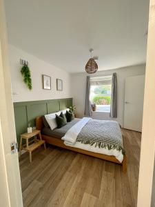 a bedroom with a large bed and a window at Central, Chic Apartment in Bournemouth